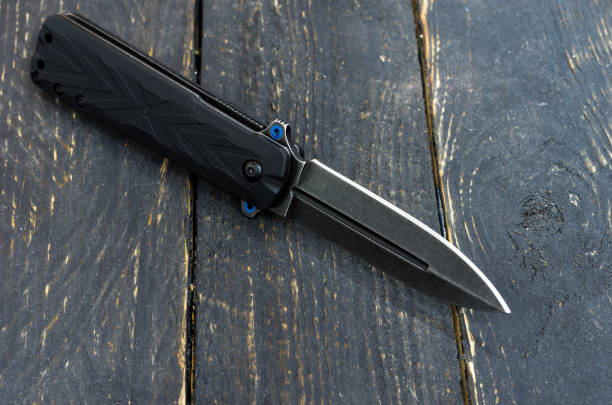 istock Black knife wooden background. Black texture. 881868476