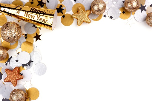 New Years Eve corner border of confetti and party decor isolated on a white background