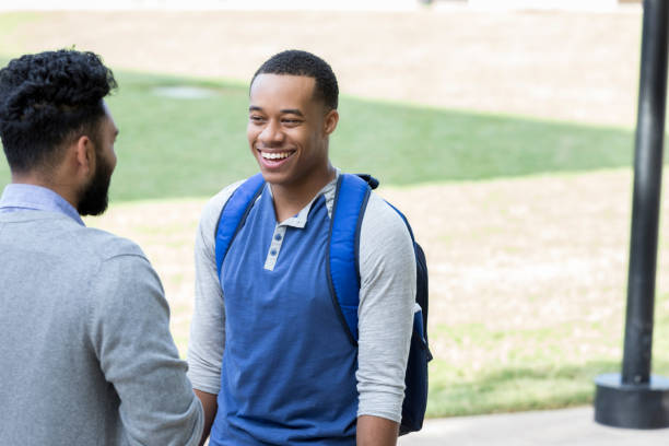 istock Male college friends talk outdoors on campus 881879190