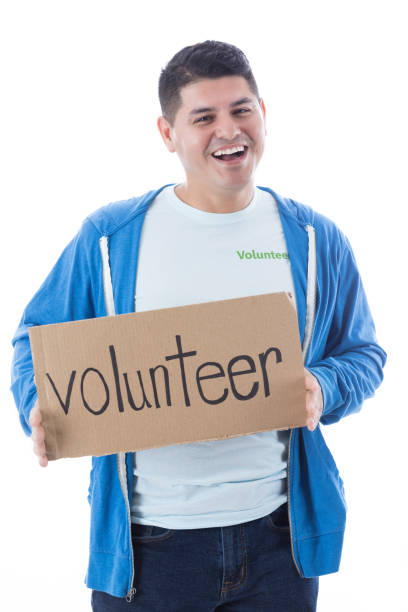 istock Cheerful Hispanic man holding volunteer sign 881881456