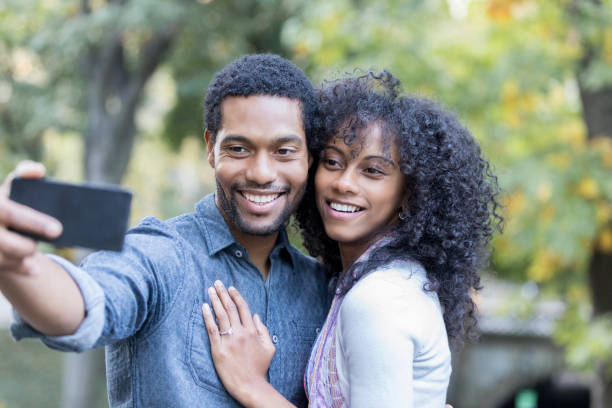 istock Young couple posing for selfie 881881706