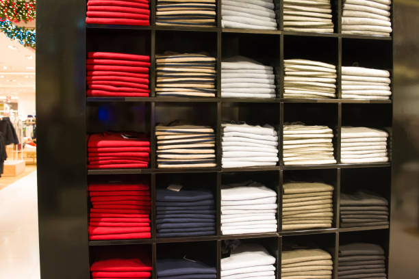 istock A row of folded jackets on a shelf in a store 881881724