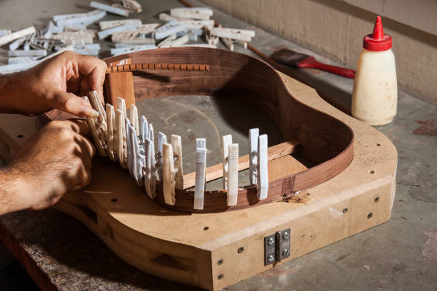 istock Luthier making an acoustic guitar body 881885182