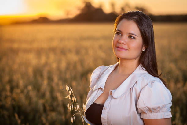 istock A girl on the oatmeal fields at sunset 881885324