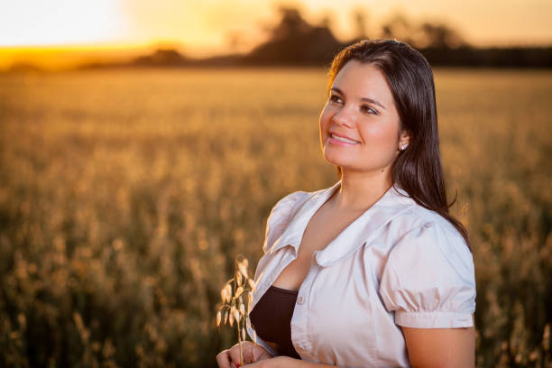 istock A girl on the oatmeal fields at sunset 881885326