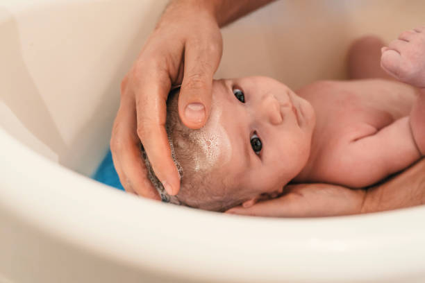 istock Bath time for a cute little newborn baby 881886256