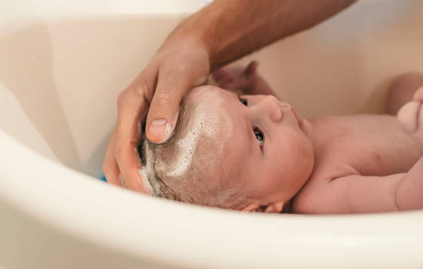 istock Bath time for a cute little newborn baby 881886260