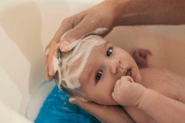 istock Bath time for a cute little newborn baby 881886876