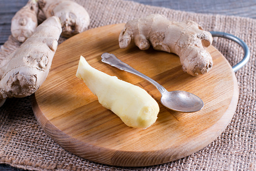 Peeled ginger root on a cutting board