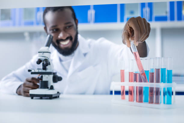 istock Selective focus of a test tube with pink liquid 881889520