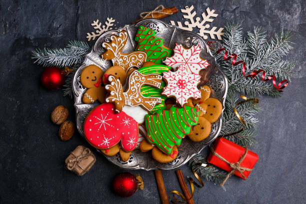 istock A plate with cookies around scattered holiday symbols on a stone background 881890432