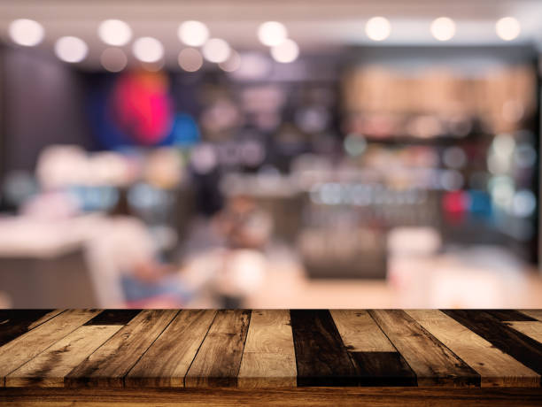 istock wood table with blurred interior in cafe background 881897340