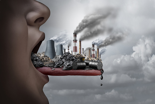 Toxic pollutants inside the human body and eating pollutants as an open mouth ingesting industrial toxins with 3D illustration elements.