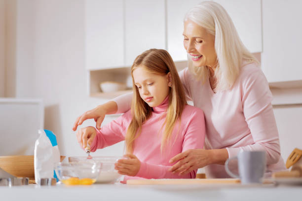 istock Nice positive woman teaching cooking 881907086