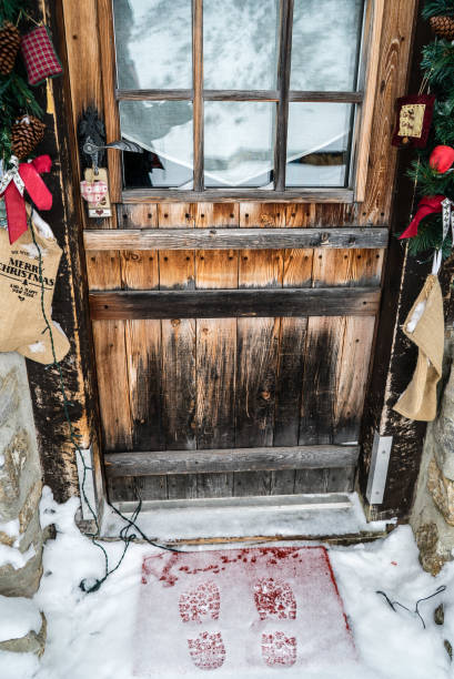istock Footsteps in snow in front of a door 881912078