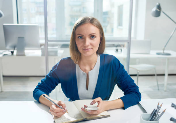 istock Positive businesswoman making notes 881924034