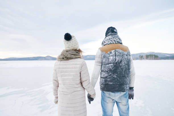 istock Pensive couple looking into distance in winter 881938846