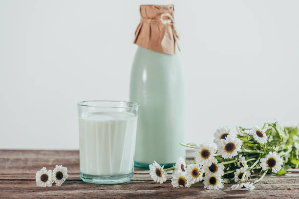 istock milk with chamomile flowers on wooden tabletop 881939288