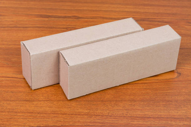 istock Empty Package brown cardboard box for long items on wooden table with copy space. 881941706