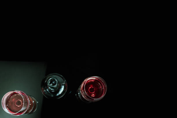 Red wine in glass on black background