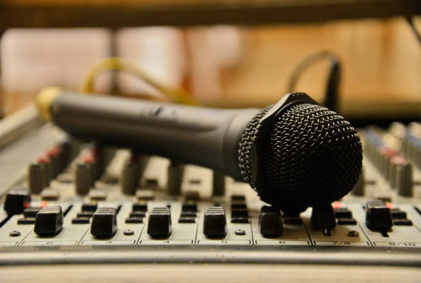 istock Microphone laying on the sound mixer. Professional audio equipment. 881949718
