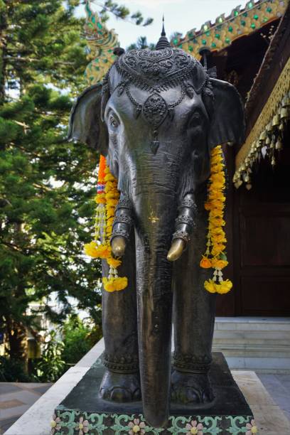 istock elephant statue with flowers in Thailand 881950054