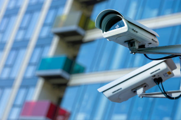 istock cctv security camera in a city with blury business building on background 881958866