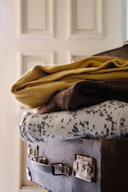 istock Cozy clothes in an antique suitcase 881959504