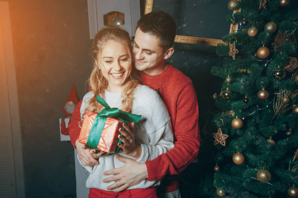 istock loving couple decorating Christmas tree 881962656