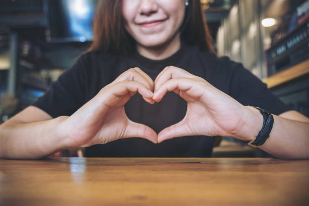 istock A smiley face Asian woman making heart hand sign with feeling inlove 881983728