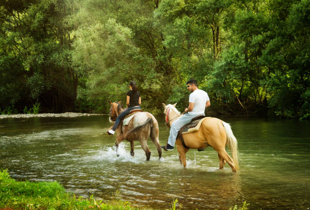 istock Couple riding horses in Italy 881984148