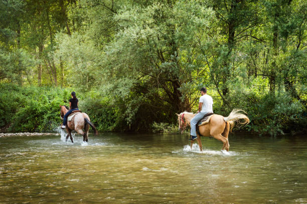 Couple riding horses in Italy