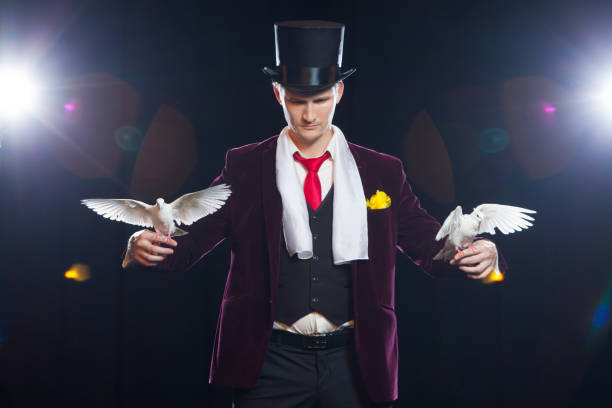 istock The magician with a two flying white Doves. on a black background 882046328