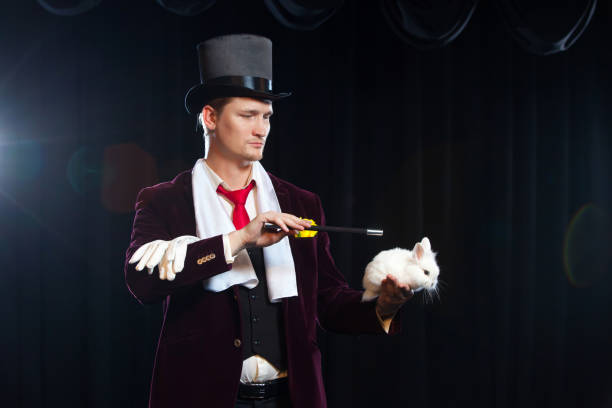 istock Magician with rabbit, Juggler man, Funny person, Black magic, Illusion on a black background 882046562