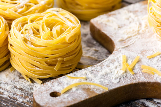 istock Homemade pasta on a wooden background 882050932