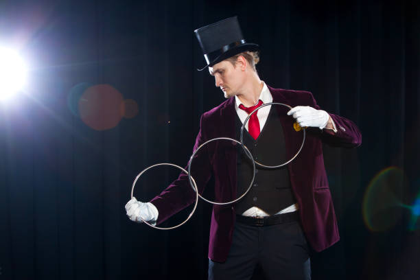 istock magic, performance, circus, show concept - magician in top hat showing trick with linking rings 882051066