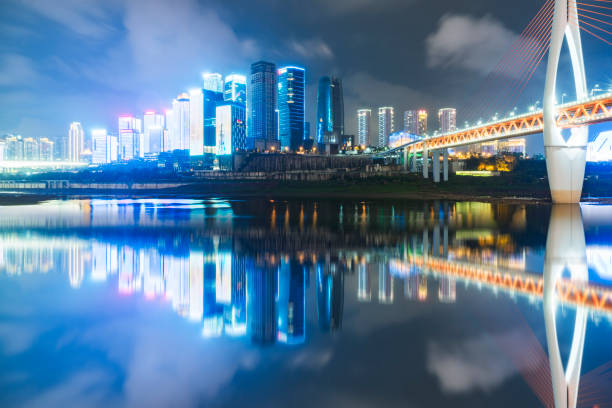 istock illuminated suspension bridge over river in modern city 882051140