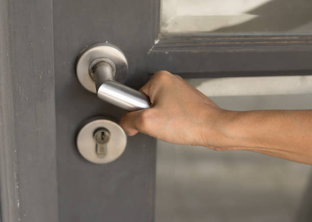 istock Female hand opening home door. 882053978