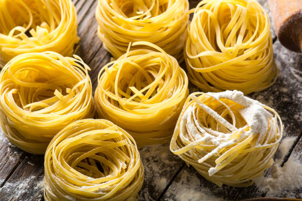 istock Homemade pasta on a wooden background 882054174