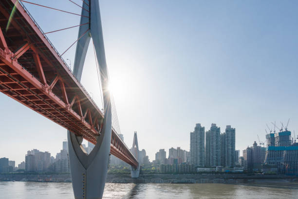 istock suspension bridge over river in modern city 882054208