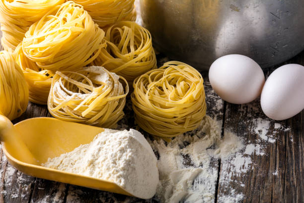 istock Homemade pasta on a wooden background 882054518