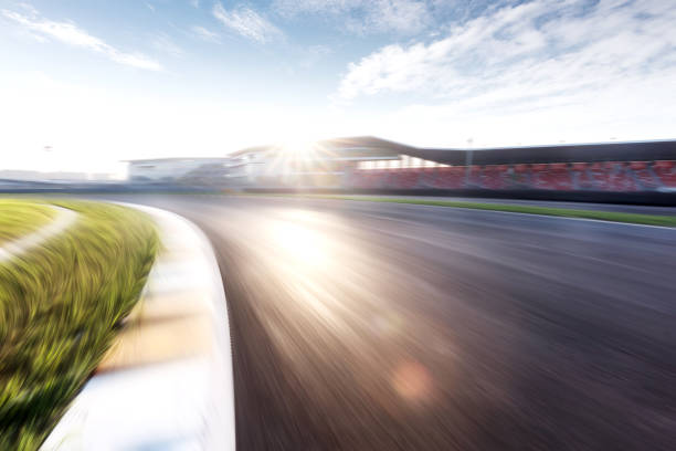 empty asphalt road in modern circuit blurry view of empty asphalt road in zhejiang shaoxing circuit in sunny sky motor racing track stock pictures, royalty-free photos & images