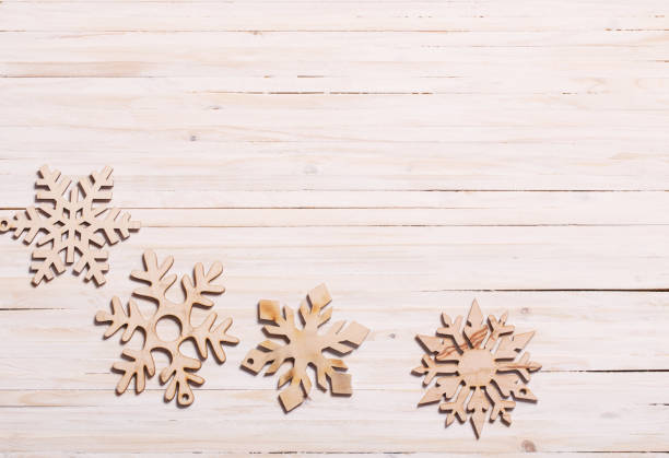 istock Snowflakes on wooden background 882070142