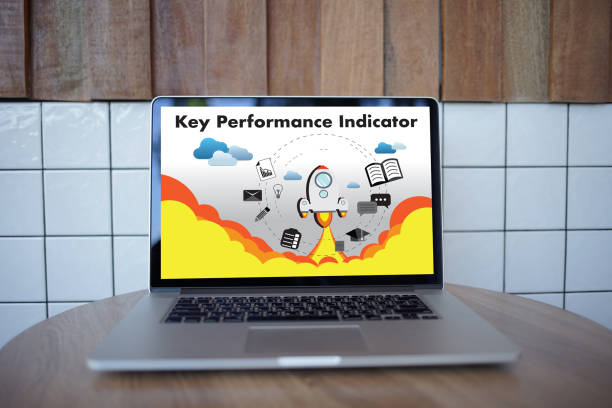 istock KPI acronym (Key Performance Indicator) Business team hands at work with financial reports and a laptop 882076130