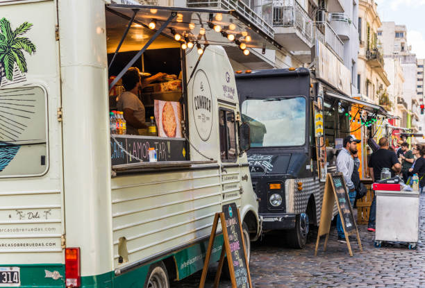 people at a street food market festival on a sunny day - food dining cooking multi colored imagens e fotografias de stock