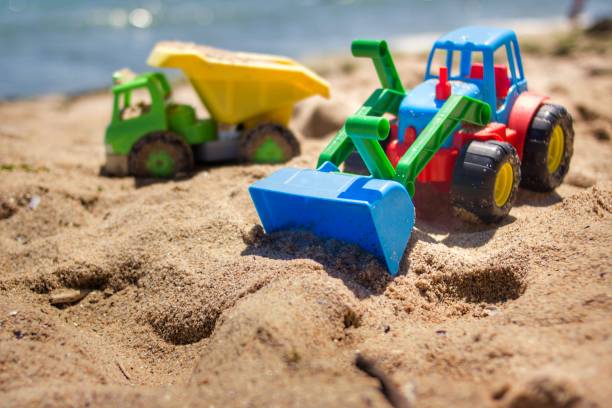 istock Children's toy on sand,industrail symbols. 882096458