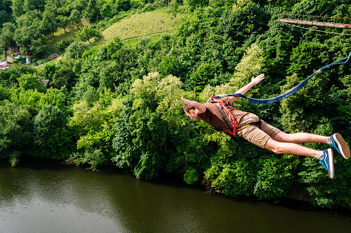Zhytomyr, Ukraine - May 30, 2015: Extreme jump from a 42 m high pedestrian bridge. Leap with a rope.