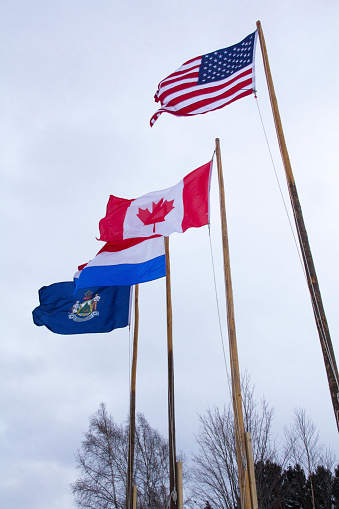 National flags fly above the winter pond hockey event in Rangeley, Maine.