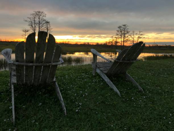 istock retirement and two chairs looking at the sunset in the swamp 882101596