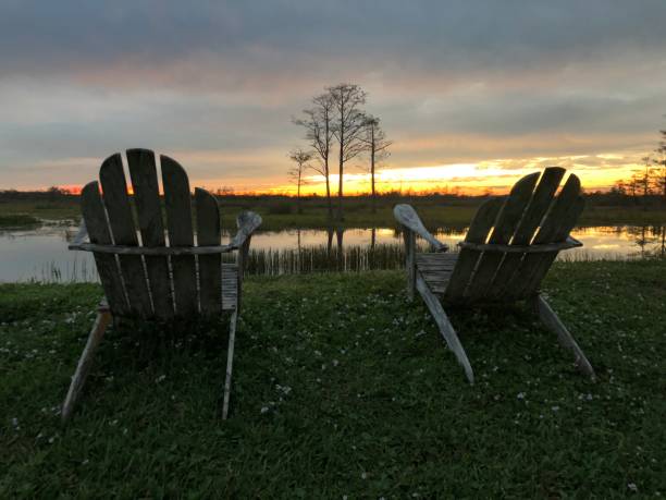 istock retirement and two chairs looking at the sunset in the swamp 882101830